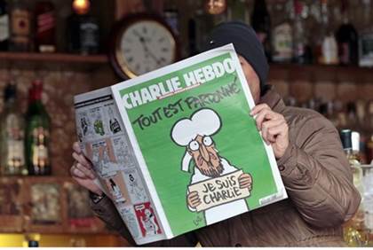 arab man reading charlie hebdo