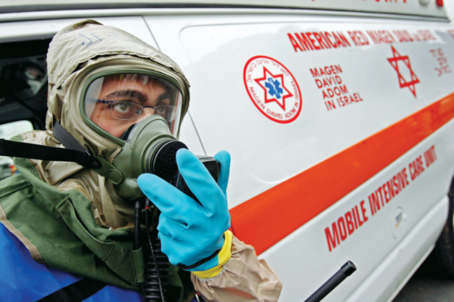 Image of MDA paramedic wearing gas mask.